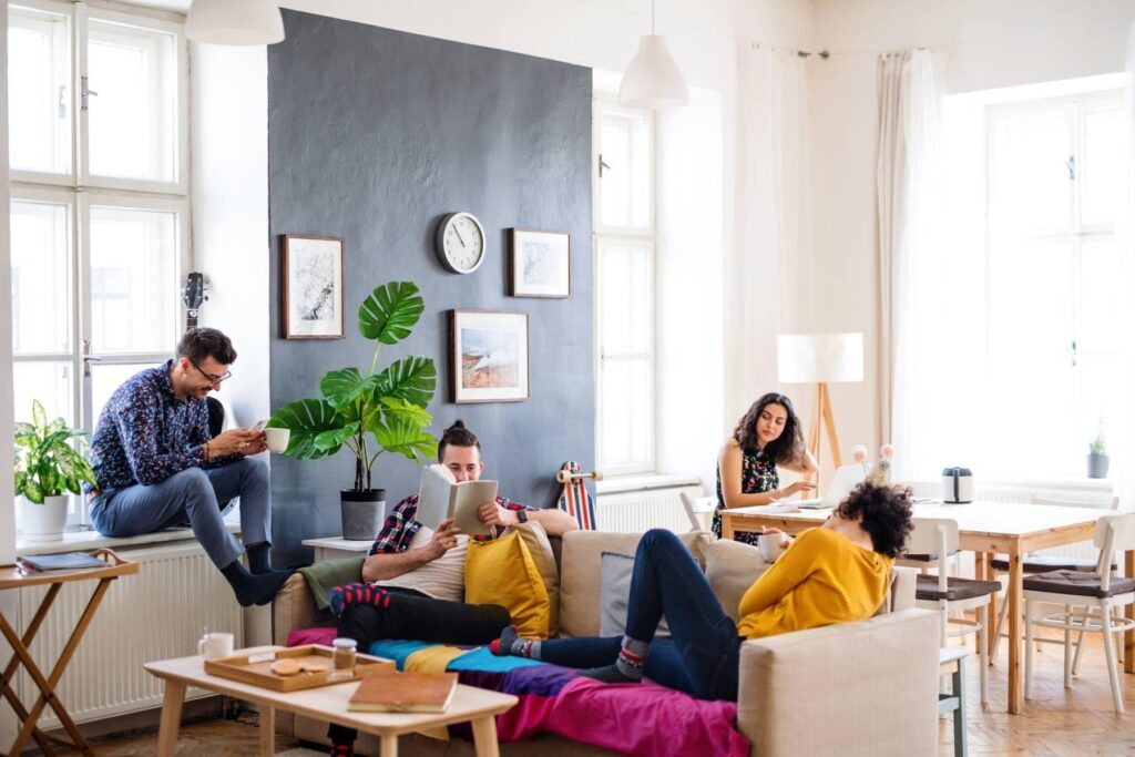 People relaxing on couches in a cosy living room setting.