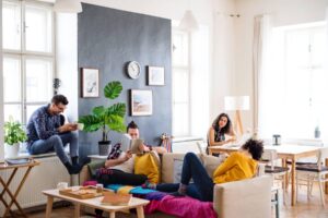 People relaxing on couches in a cosy living room setting.