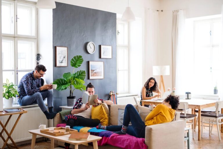 People relaxing on couches in a cosy living room setting.