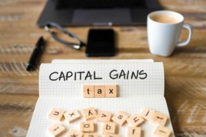 Capital gains tax concept illustrated on a notebook page.