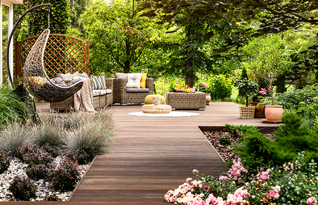 a wooden walkway with a bench and chairs