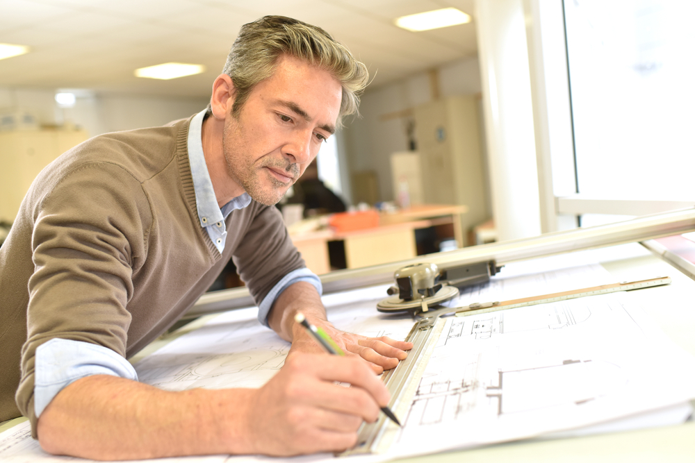 a man sitting at a desk writing