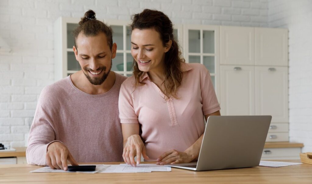 Homeowners reviewing pricing figures and buyer expectations at the kitchen table.