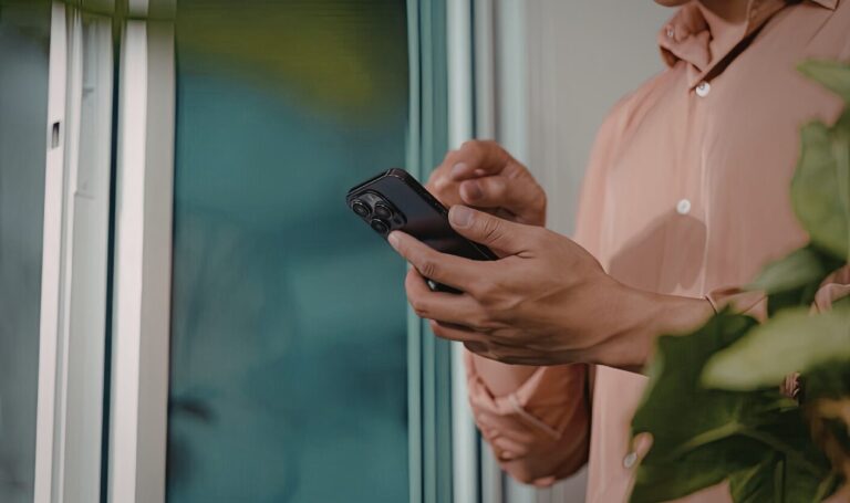 Checking an instant property valuation near a window at home