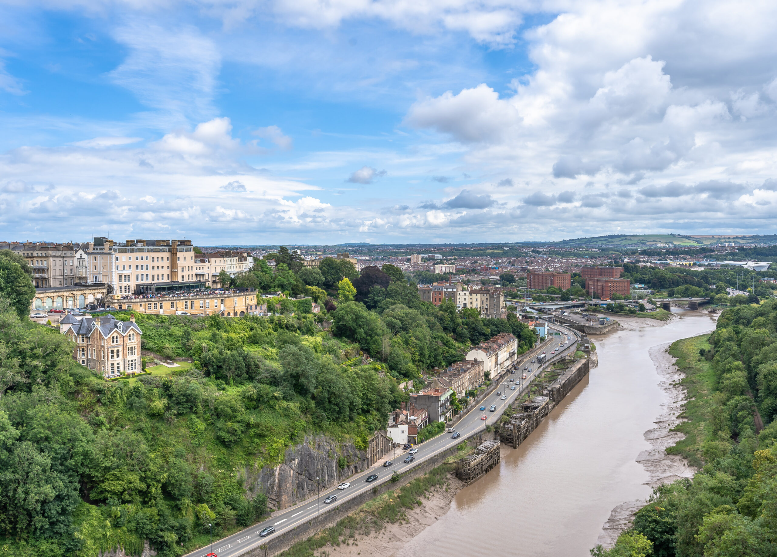 Panoramic view of Long Ashton village and Bristol landscape with countryside hills and river, representing sought-after residential areas near Bristol.