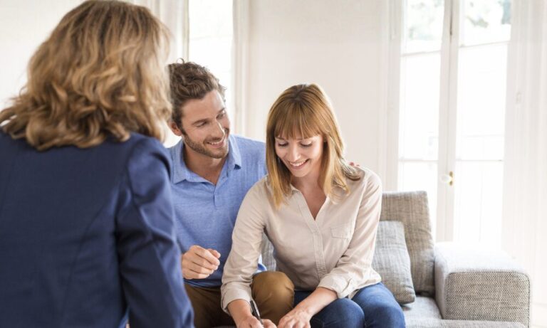 A couple signing rental paperwork with a letting agent in a bright Brislington property.