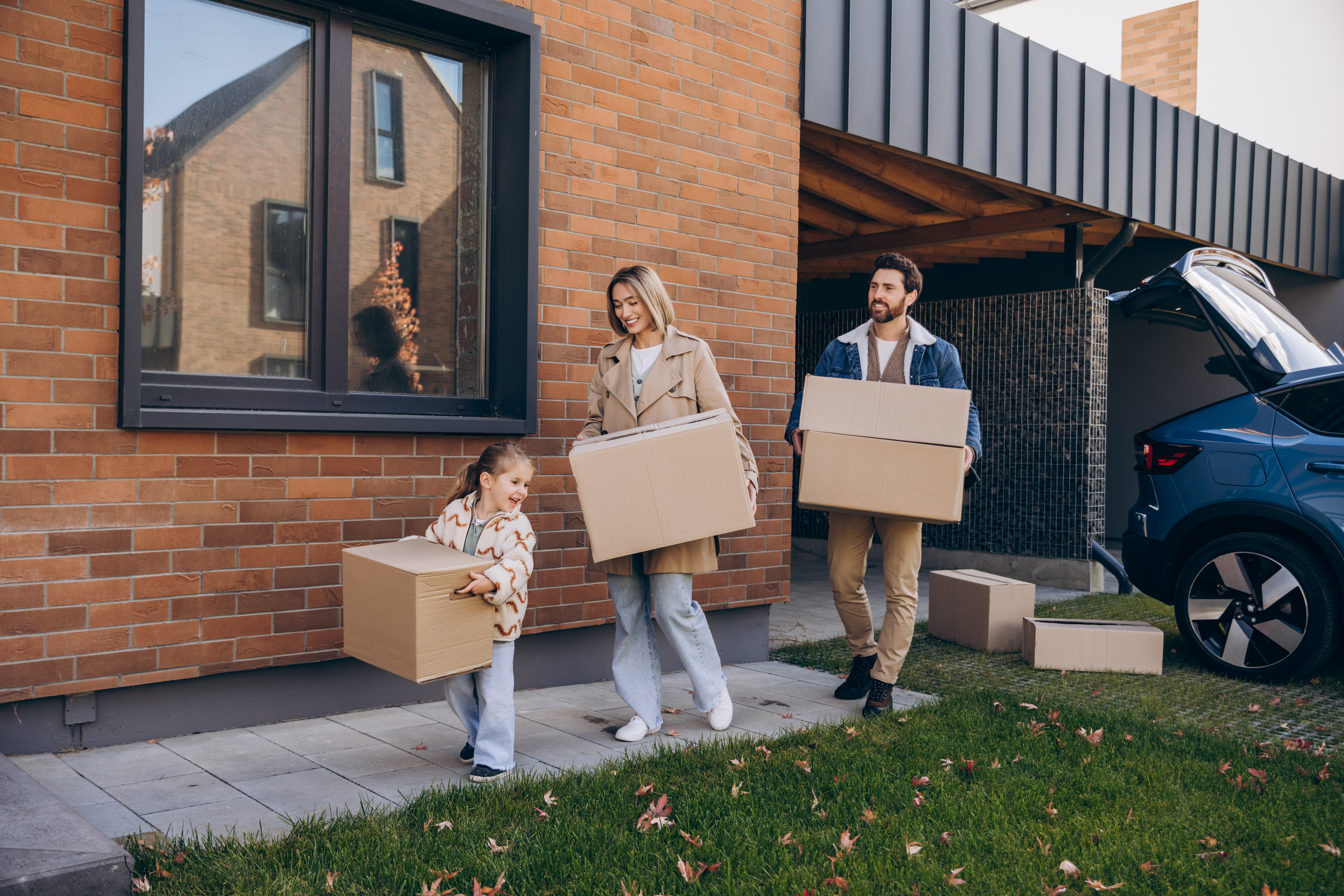 Young family carrying moving boxes into a new home in Bishopsworth, Bristol