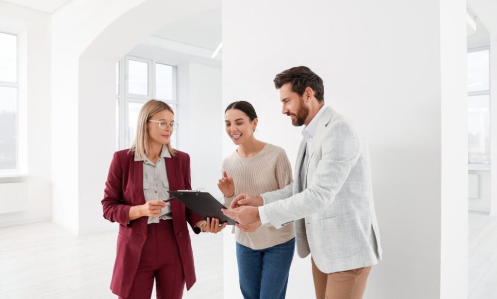 Estate agent reviewing property details with clients inside a bright rental property, representing Bishopsworth Bristol rental yields, landlord advice and BS13 buy-to-let investment.