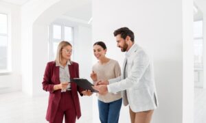 Estate agent reviewing property details with clients inside a bright rental property, representing Bishopsworth Bristol rental yields, landlord advice and BS13 buy-to-let investment.