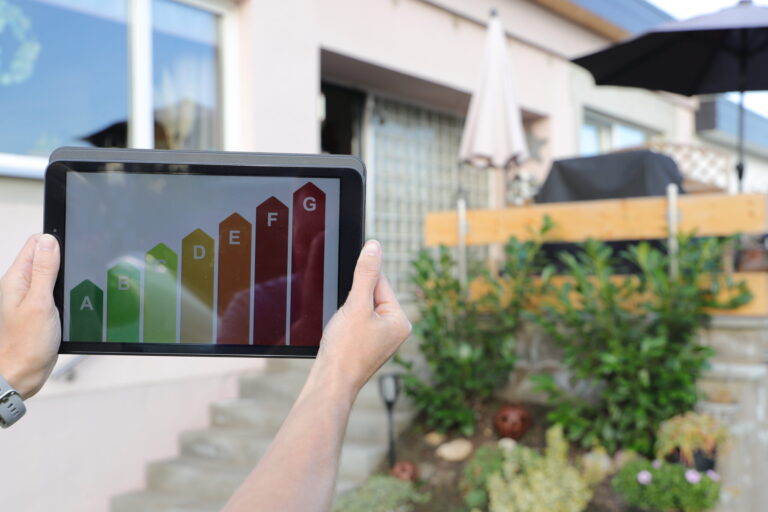 Person holding an EPC rating chart outside a residential property, representing energy efficiency and buy-to-let returns in Brislington.