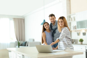 Estate agent showing property details to homeowners in a bright kitchen, representing sellers reviewing Southville terraced house values.