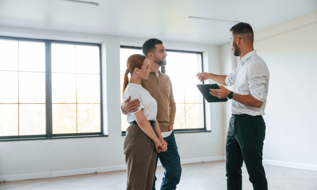 Property agent discussing a rental property with a couple during a viewing