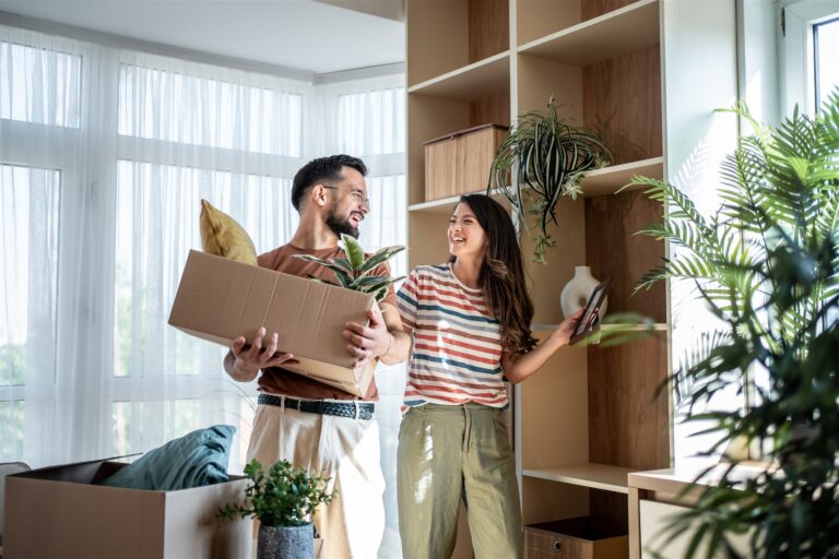 Couple unpacking plants after moving into a Southville home